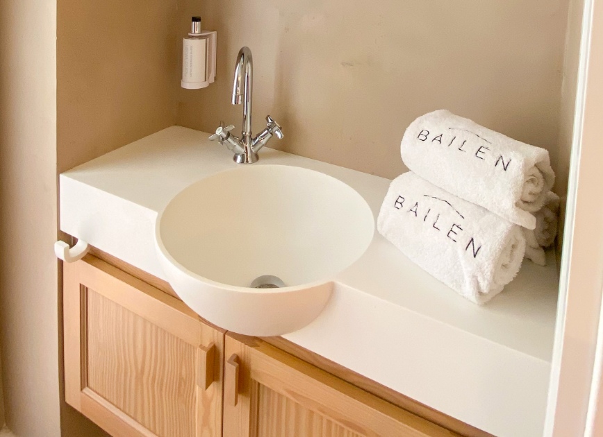 Hand wash basin with neatly folded towels