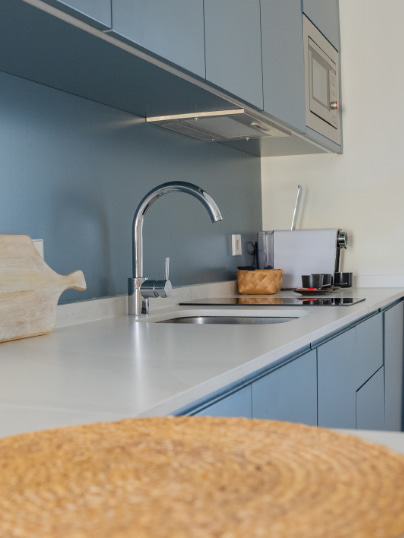 Kitchen island with sink and wall-mounted cupboards